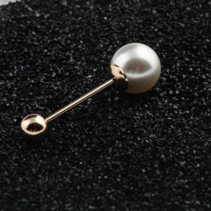 Close-up detail of a double-headed screw brooch featuring white pearl and gold finish