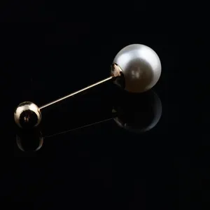 Elegant double-ended pearl brooch pin with reflective black background studio shot