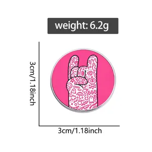 Detail view of a rock hand doodle pin with weight and size measurements