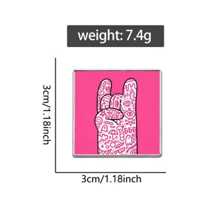 Detail view of square pink rock gesture metal pin with hand-painted doodle pattern
