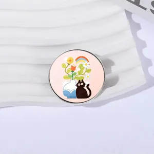 Cute circular metal brooch badge featuring a black cat and floral vase illustration