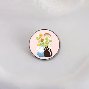 Enamel lapel pin featuring a cute black cat sitting by a floral vase with a rainbow