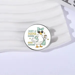 Cartoon mama duck enamel pin with Raising Good Humans quote badge for clothes