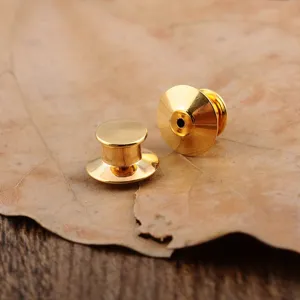 Macro detail of two premium gold-plated metal pin backs for DIY brooch making craft