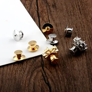 Close-up of gold and silver plated locking pin backs and crystal brooch accessories