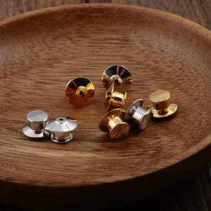 Close-up of polished gold and silver metal pin backs for DIY brooch jewelry making