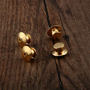 Detail view of four gold-plated metal pin backs for DIY brooch making accessories.