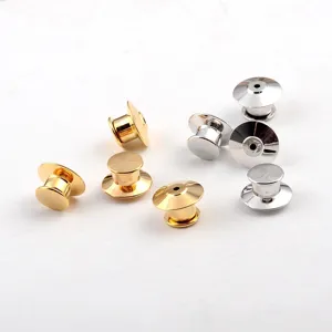 Detailed macro view of gold and silver metal locking pin backs for brooch DIY crafts