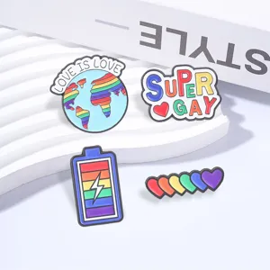 Set of four colorful Pride enamel pins featuring rainbow hearts and motivational motifs