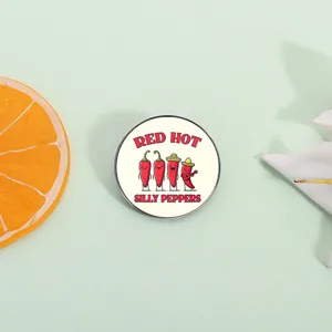 Red Hot Silly Peppers enamel pin with cute cartoon chili characters on green background