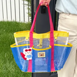 Detailed view of the colorful mesh beach bag with contrast handles, multiple pockets, and cute keychain.