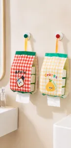 Hanging fabric tissue holder with cute apple and orange print, ideal for bathroom use.