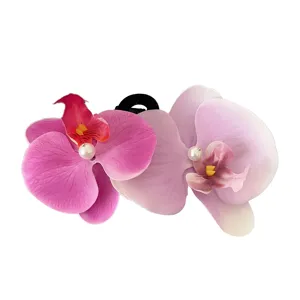 Elegant butterfly orchid hair clip with pink and purple gradient flowers and pearls.