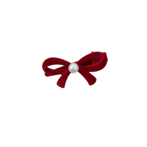 Elegant red velvet bow hair clip with a white central pearl on plain white background