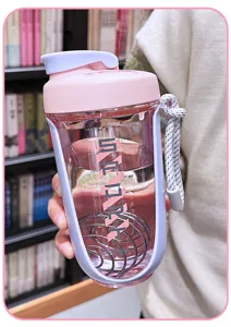 Large capacity plastic protein shaker bottle with mixing ball, pink and purple design for sports.