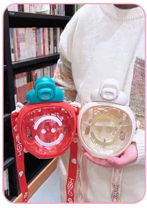 Detail view of the cute strawberry water bottle with straw and strap, perfect daily use.