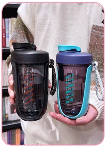 Detail view of large capacity plastic shaker bottle with scale marks and portable strap for gym.