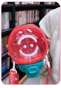 Detail view of the cute strawberry water bottle with straw and shoulder strap, 750ml.