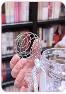 Stainless steel blender ball and plastic shaker bottle for protein shakes and fitness drinks.