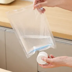 Portable mini magnetic sealing machine and vacuum food storage bags for home kitchen use.