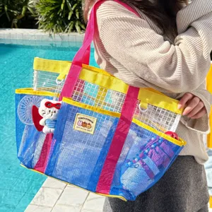 Detailed view of colorful mesh beach tote bag poolside, large capacity travel storage.