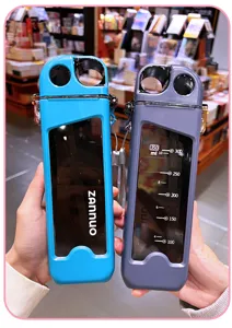 Detail view of square plastic water bottle with straw and capacity scale, portable design.