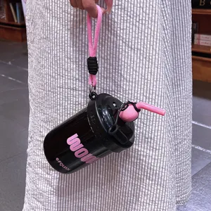 Portable tumbler with straw and pink strap, stylish black insulated water bottle for daily use.
