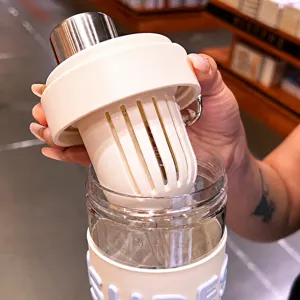 Portable tea water separation water bottle with large infuser basket and straw for office use.