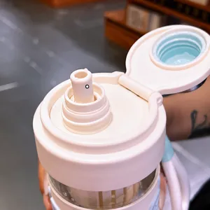 Portable plastic water bottle with straw lid design, safe material for daily office use.