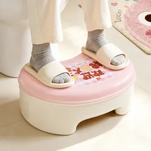 Ergonomic plastic toilet foot stool in pink and white for bathroom use, anti-slip design.