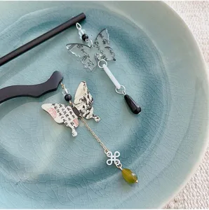 Detail view of New Chinese style butterfly hairpins with elegant ink wash calligraphy