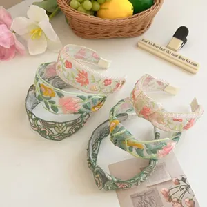 Multiple embroidered mesh headbands featuring delicate floral patterns and mesh fabric