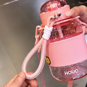 Pink portable plastic water bottle with cute strap, ideal for kids and outdoor daily use.