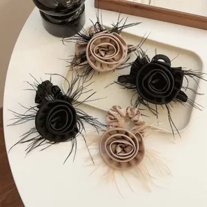 Elegant French style hair clips with fabric roses and feathers in black and beige.