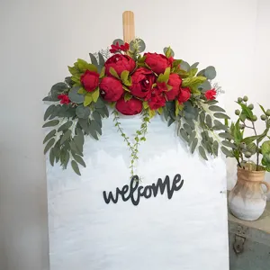 Artificial red peony flower arrangement wall hanging decor with eucalyptus leaves for home wedding.