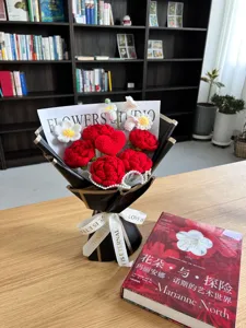 Handmade crochet red rose flower bouquet detail with heart shape and nice black wrapping wrap.
