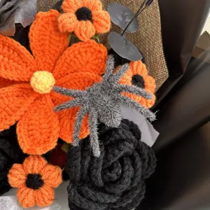 Handmade crochet Halloween flower bouquet with black and orange blooms and fuzzy spider.
