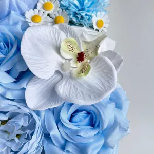 Detailansicht künstlicher blauer Rosen und weißer Orchideen für DIY-Geschenkbox und Hochzeit.