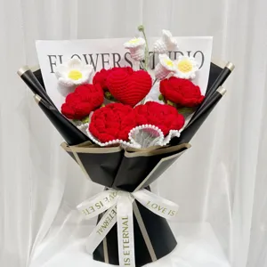 Handcrafted crochet red rose heart flower bouquet with elegant black wrapping paper for romantic gifts.