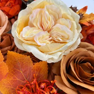 Autumn artificial flower detail view, rose petals and maple leaves for DIY wedding party bouquet.