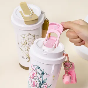 Cute dual-drinking portable coffee cup with strap and cute pendant for daily office use.