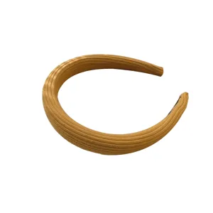 Comfortable mustard yellow knitted padded headband featuring a stylish ribbed texture design