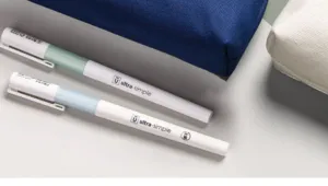 Close-up detail view of minimalist neutral pens presented with canvas pencil pouches.