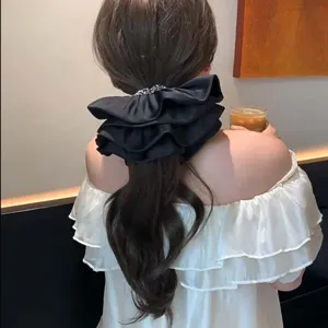 Elegant large French satin ruffled scrunchie for stylish ponytail and bun hair styling.