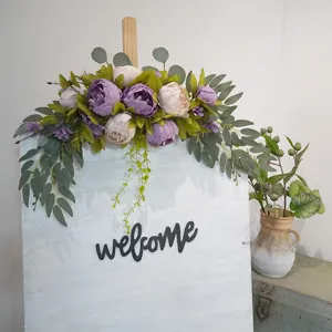 Artificial peony flower arrangement with eucalyptus leaves for wall hanging and wedding decor detail.