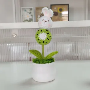 Handmade crochet potted plant featuring a cute rabbit and kiwi flower, ideal decor gift.