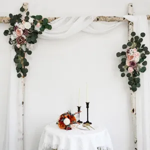 Wedding arch floral arrangement with artificial roses, eucalyptus leaves and white drape for