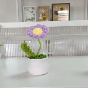 Handcrafted crochet flower potted plant detail, cute knitted daisy decor for home desk.
