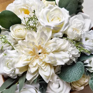 Handmade artificial silk flower bouquet detail, white roses and eucalyptus leaves for wedding.