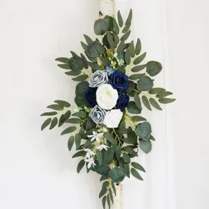 Detailed view of artificial eucalyptus and rose floral swag for wedding arch decor.